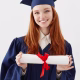 close-up-portrait-happy-foxy-woman-graduate-cap-smiling-holding-diploma-young-redhead-woman-student-future-lawyer-engineer_176420-14233